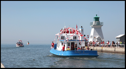Port Dover Pier and Canada Day boat parade, sailing past lighthouse on the Gold Coast in Southern Ontario